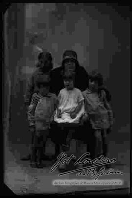 Foto de estudio de una familia. Una dama con sus cuatro hijos