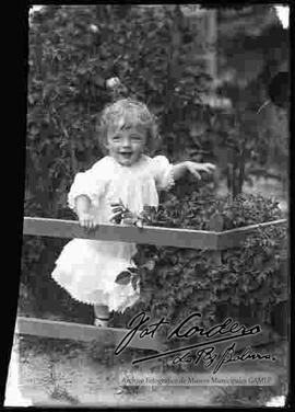 Imagen de una niña en el jardín de una casa particular