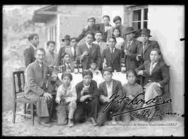 Un grupo de jóvenes y adultos varones, compartiendo bebidas en el patio de una casa particular