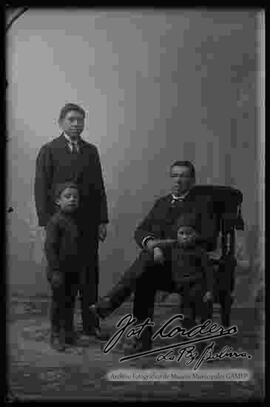 Foto de estudio de una familia. padre con sus tres hijos