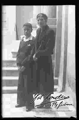 Una dama junto a su hijo en el patio del estudio fotográfico cordero