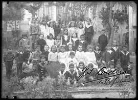 Grupo de niños y niñas en el jardín de una casa particular celebrando un cumpleaños