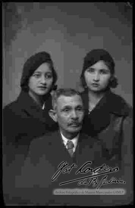 Foto de estudio de un padre junto a sus dos hijas