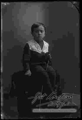 Foto de estudio de un niño sentado encima de un sillón